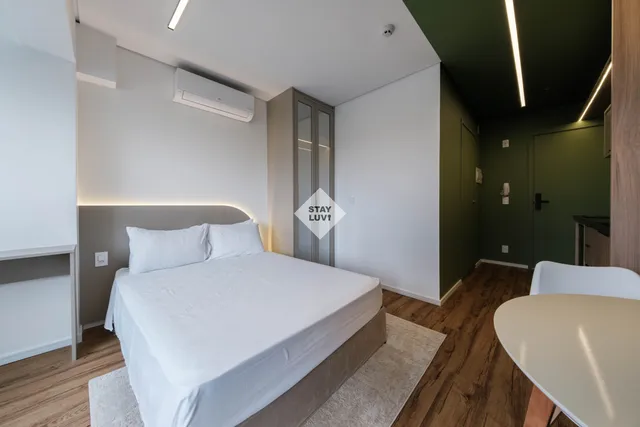 Sala de apartamento com sofá, almofadas e tapete em ambiente aconchegante